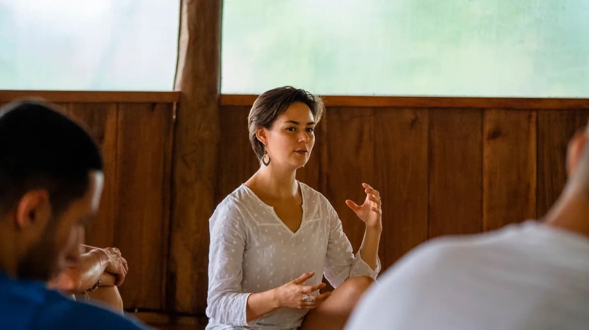 Facilitator guiding a seated group conversation